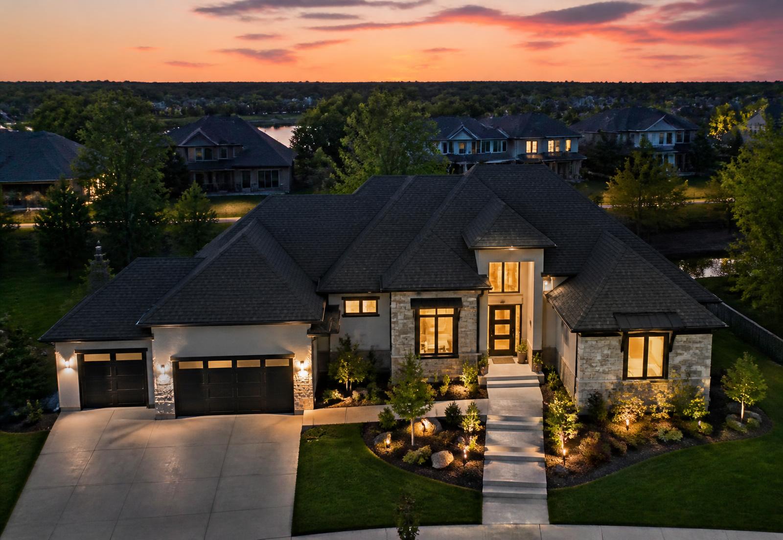 Completed home with a new roof at dusk in an upscale suburban neighborhood